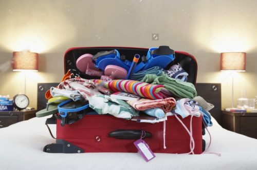 stock-photo-open-suitcase-on-bed-145225978